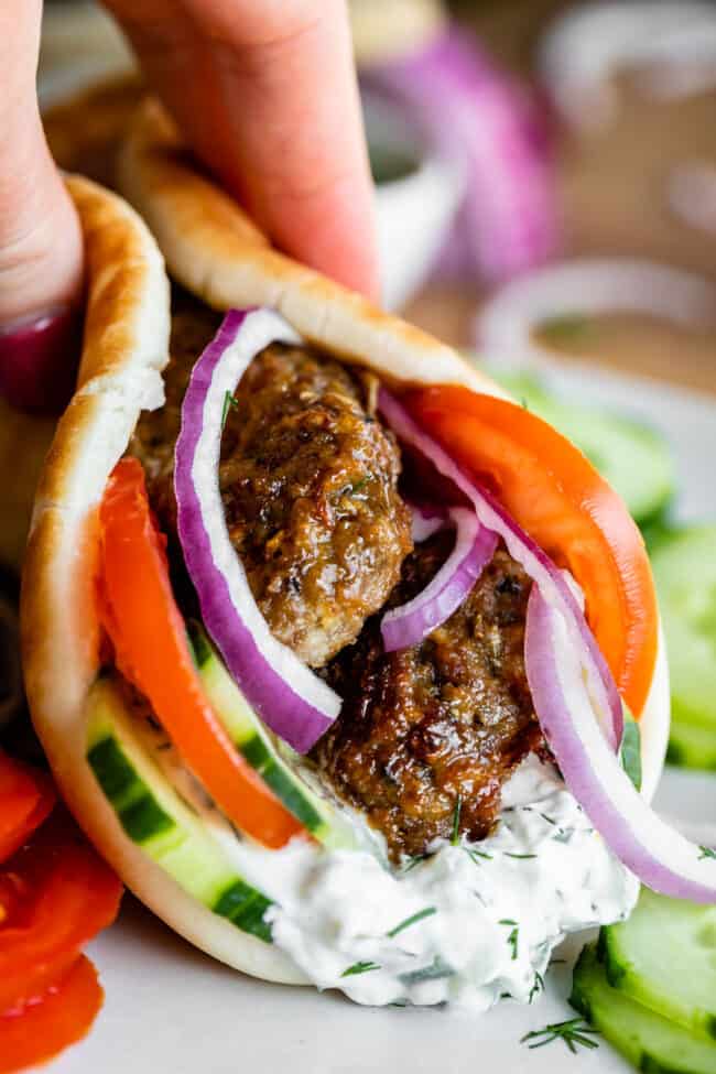 Greek gyro with pita, gyro meat, tomatoes, red onion, cucumber, and tzatziki sauce.