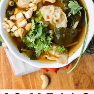 A bowl of soup with dumplings, greens, cashews, and cilantro sits on a napkin. Text below reads: โ10 pantry meals you can make using ingredients you already have.โ.