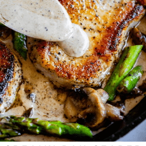 pork chops with creamy mushroom gravy and asparagus.