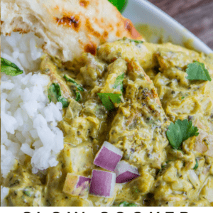 A hand dips naan bread into a bowl of flavorful basil chicken coconut curry served with white rice, garnished with red onions and cilantro. Text reads: Slow Cooker Basil Chicken in Coconut Curry - The Food Charlatan.