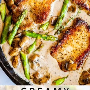 A skillet with creamy pork chops in sauce, asparagus, and mushrooms, with the text “Creamy Pan Seared Pork Chops with Asparagus” at the bottom of the image.