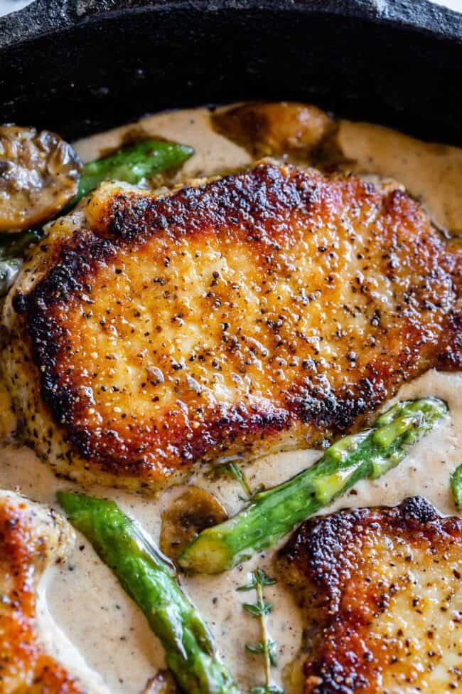 seared pork chops in creamy gravy with mushrooms, asparagus, and fresh thyme. 