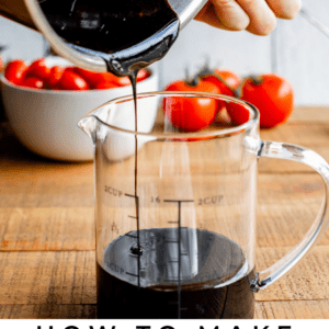 balsamic vinegar reduction being poured into a glass measuring cup.