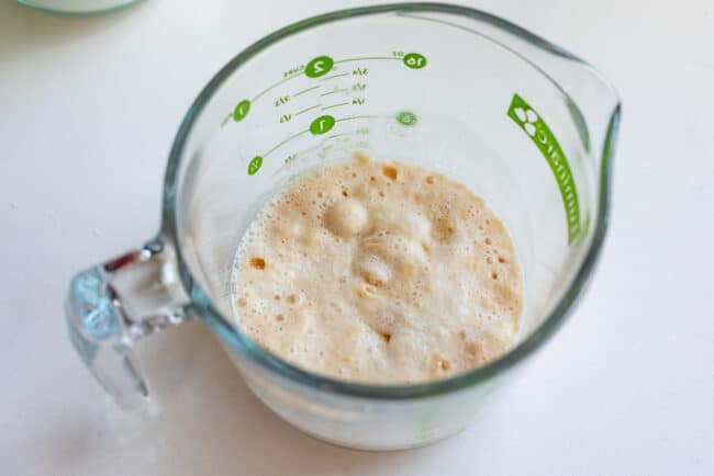 yeast proofing in a glass measuring cup.