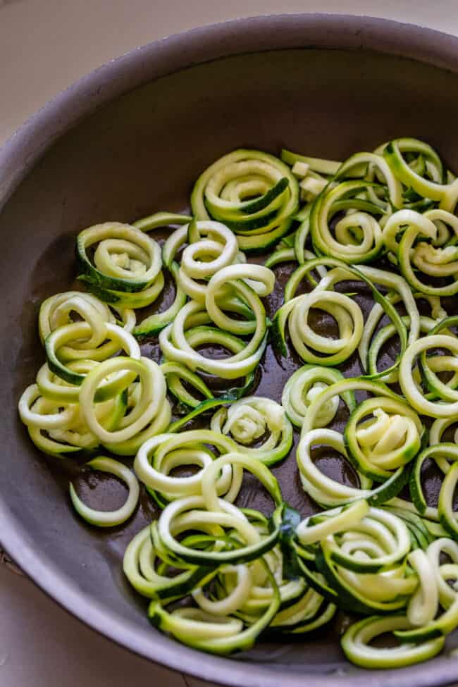 curly zoodles in a frying pan 