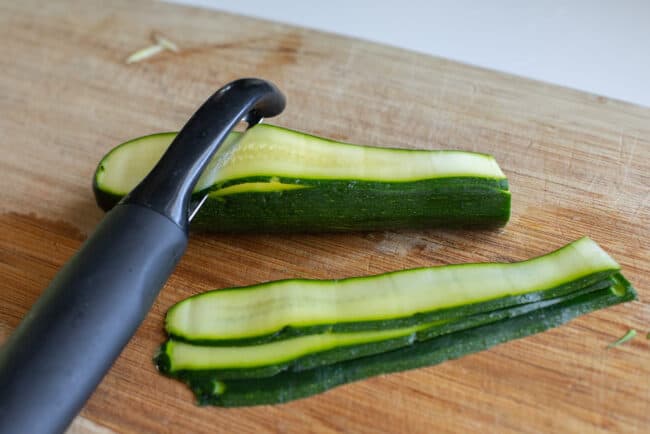 peeling zucchini into ribbons using a vegetable peeler