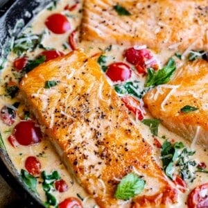 tuscan salmon with cherry tomatoes, spinach, and cream sauce.
