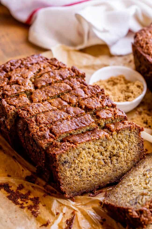 Banana bread cut into slices on parchment paper.