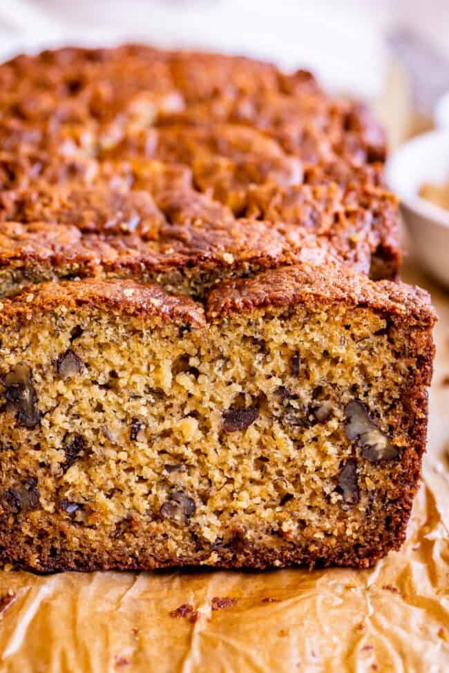 moist banana bread recipe showing nuts inside a slice.