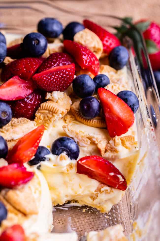 golden oreo dessert with strawberries and blueberries in a pan