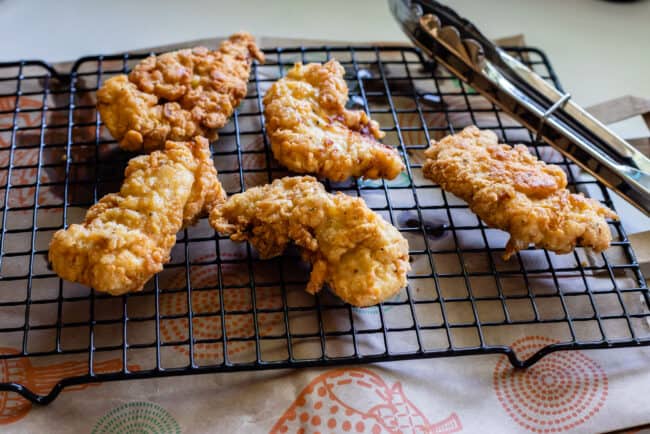 fried chicken cooling on a rack