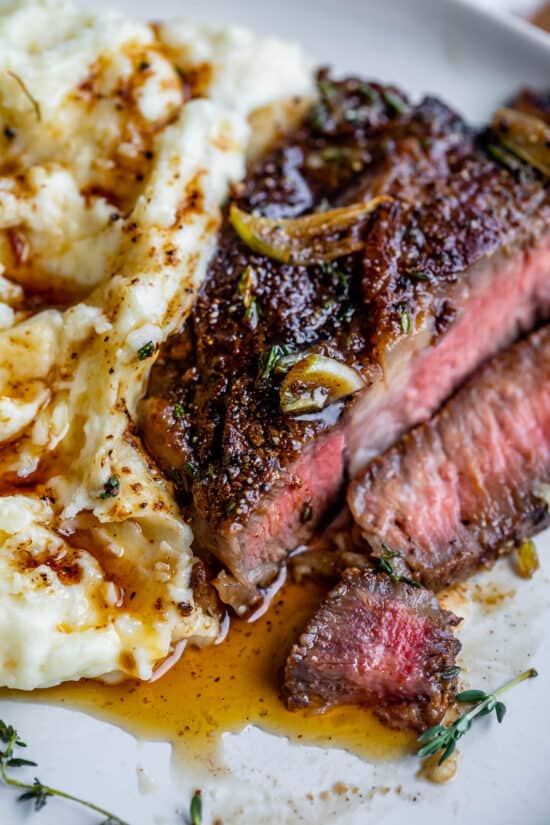 how to cook steak slices next to mashed potatoes, all drizzled with gravy