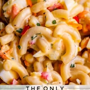 Close-up of creamy macaroni salad with elbow pasta, chopped vegetables, and herbs mixed together. Text at the bottom reads: The Only Macaroni Salad You Need for your next gathering. Try this irresistible macaroni salad recipe today!.