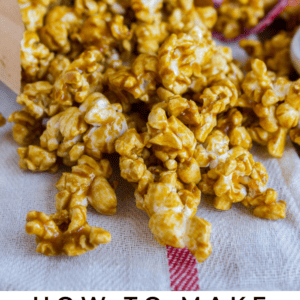Caramel Popcorn spilling out of a brown paper bag onto a cloth surface, with the text “10 Minute Caramel Popcorn” and “The Food Charlatan” at the bottom.