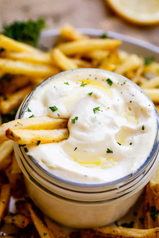 garlic aioli sauce in a jar with french fries.