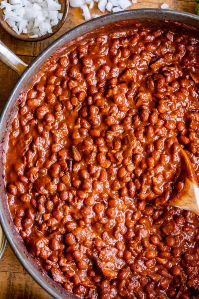 pinquito beans in a pan with a spoon.