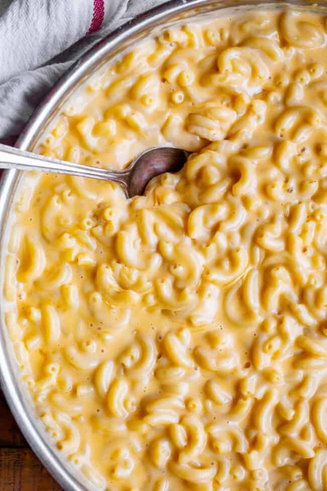 overhead shot of a big bowl of creamy macaroni and cheese with a spoon.