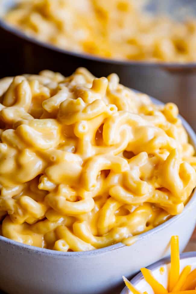 a bowl piled high with mac and cheese shot from the side