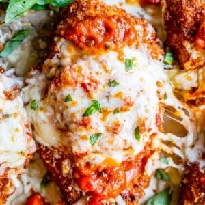 crispy chicken parmesan on a pan with cheese stretch; shot from overhead