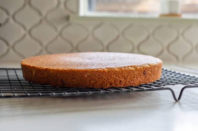 flat layer cake on a cooling rack.