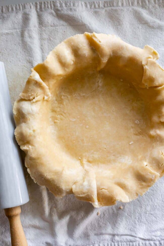 never fail flaky pie crust in a pie pan with a rolling pin