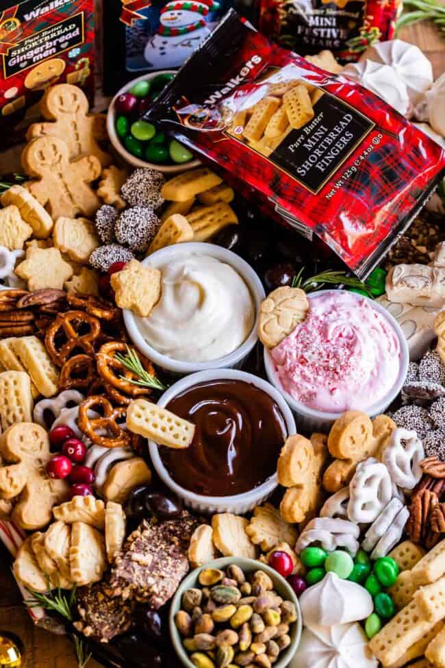 dessert charcuterie on a large board with shortbread, dips, pretzels, toffee, candy.