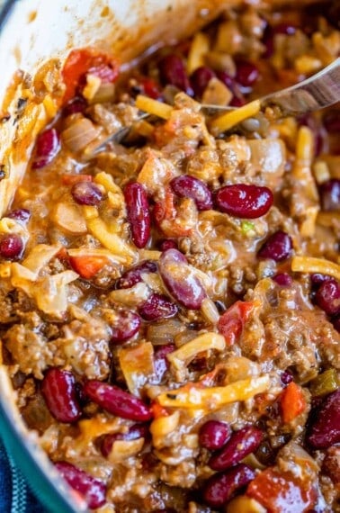 quick chili recipe in a pot mixed with cheese and sour cream