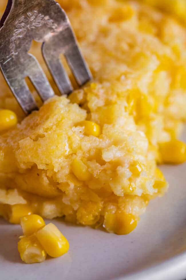 close up shot of cream corn casserole with a fork in it.