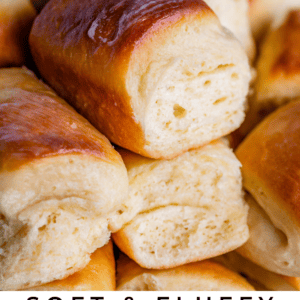 A close-up of golden-brown, soft and fluffy Parker House rolls stacked together, highlighting their tender, airy texture. Text reads: Buttery & Fluffy Parker House Rolls – The Food Charlatan.