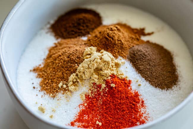 sugar and spices in a bowl being used as a dry rub for ham.