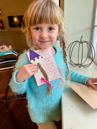 Daughter holding homemade Rapunzel birthday card.