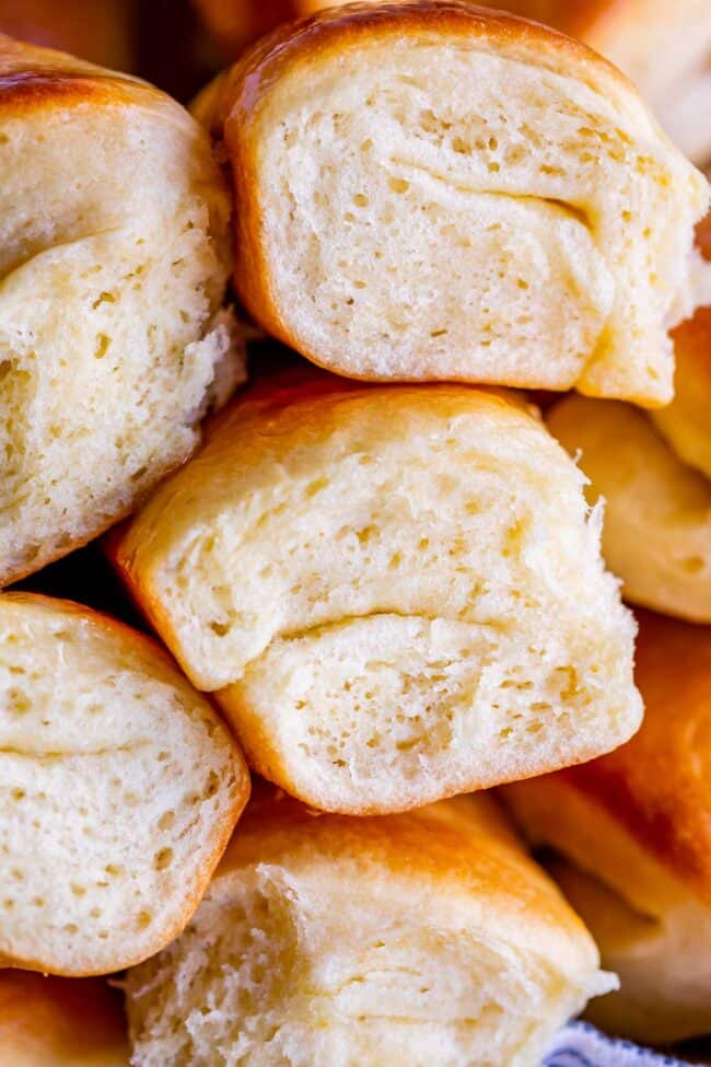 parker house dinner rolls, stacked together and shot from the side.