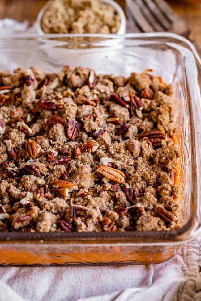streusel topped sweet potato casserole in a glass dish.