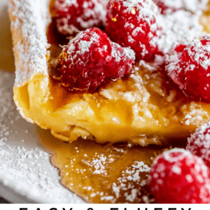 german pancakes with fresh raspberries and powdered sugar.