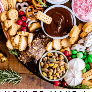 A dessert charcuterie board with cookies, pretzels, chocolate, dips, meringues, pistachios, berries, and festive decorations is displayed from above. Text below reads: Dessert Charcuterie Board Ideas.
