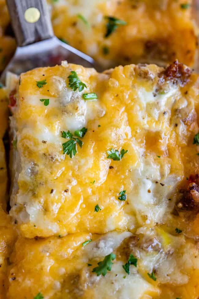 sausage and egg breakfast casserole with parsley sprinkled on top.