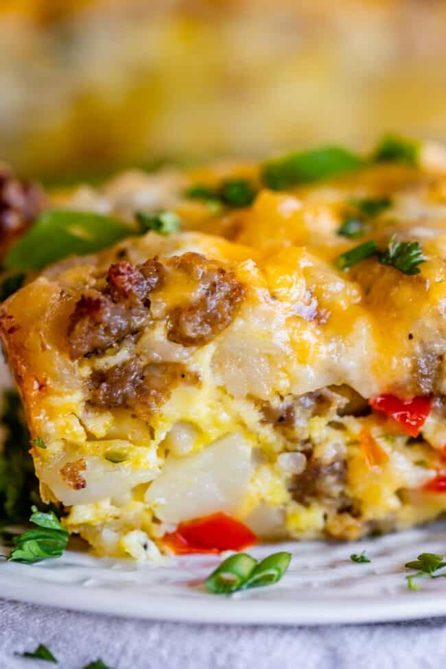 breakfast casserole with sausage and hashbrowns on a white plate. 