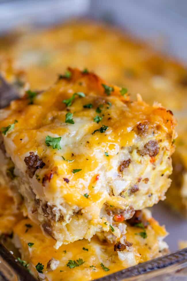 sausage breakfast casserole lifted on a serving spoon.