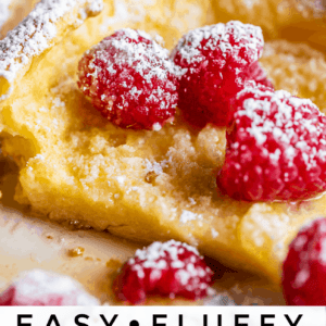 A close-up of a fluffy Dutch baby, a type of German pancake, topped with fresh raspberries and sprinkled with powdered sugar. The text at the bottom reads Easy • Fluffy Dutch Baby Pancakes.