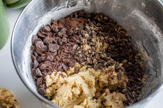 a mixing bowl with andes mints and dark chocolate ready to mix into cookie dough