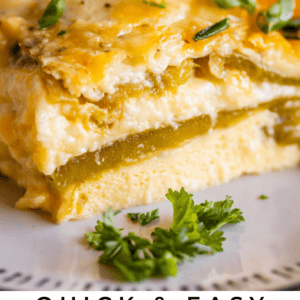 A close-up of a cheesy chile relleno casserole slice, topped with chopped cilantro, served on a white plate. Text at the bottom reads “Quick & Easy Chile Relleno Casserole – The Food Charlatan.”.