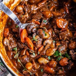 overhead shot of beef bourguignon recipe in a pot with a spoon