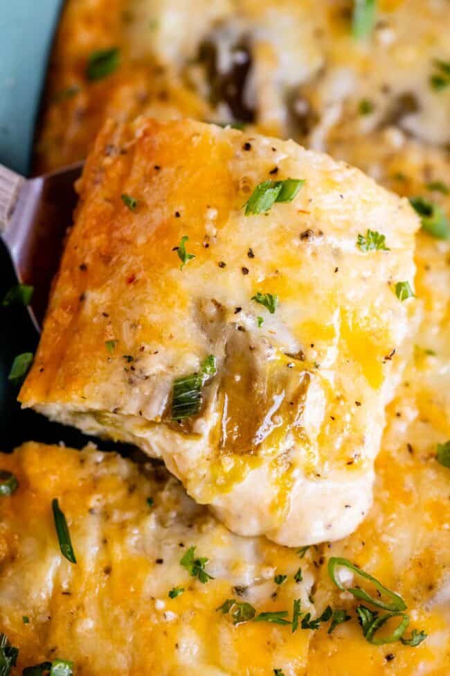 green chile egg breakfast casserole being lifted from the pan.