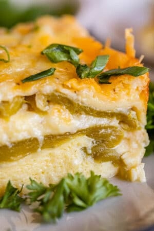 chile relleno breakfast casserole with chopped green onions on a plate