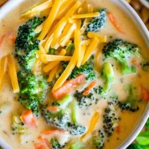 how to make broccoli and cheese soup, in a bowl with cheese sprinkled on top