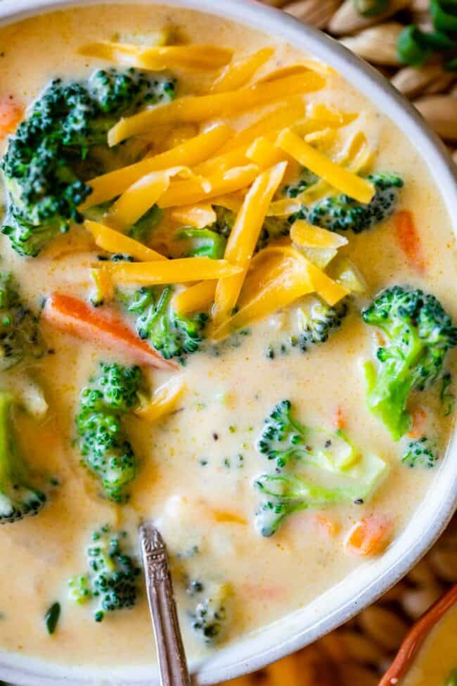 overhead shot of broccoli cheese soup with cheddar cheese on top.