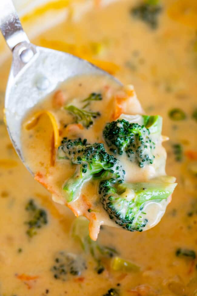 quick broccoli cheese soup being lifted from a pot with a large spoon