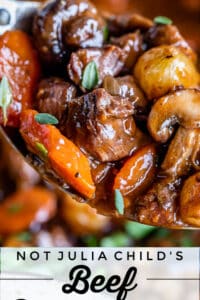 close up shot of beef bourguignon with beef, carrots, mushrooms, and onions on a spoon