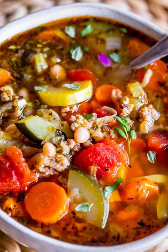 turkey vegetable soup (weight loss soup) recipe in a white bowl with a spoon. 