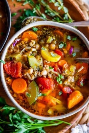turkey vegetable soup recipe in a bowl on a wooden plate